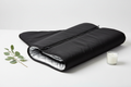 AURAVITA Infrared Sauna Wrap — premium black sauna blanket partially unrolled showing interior lining and zipper